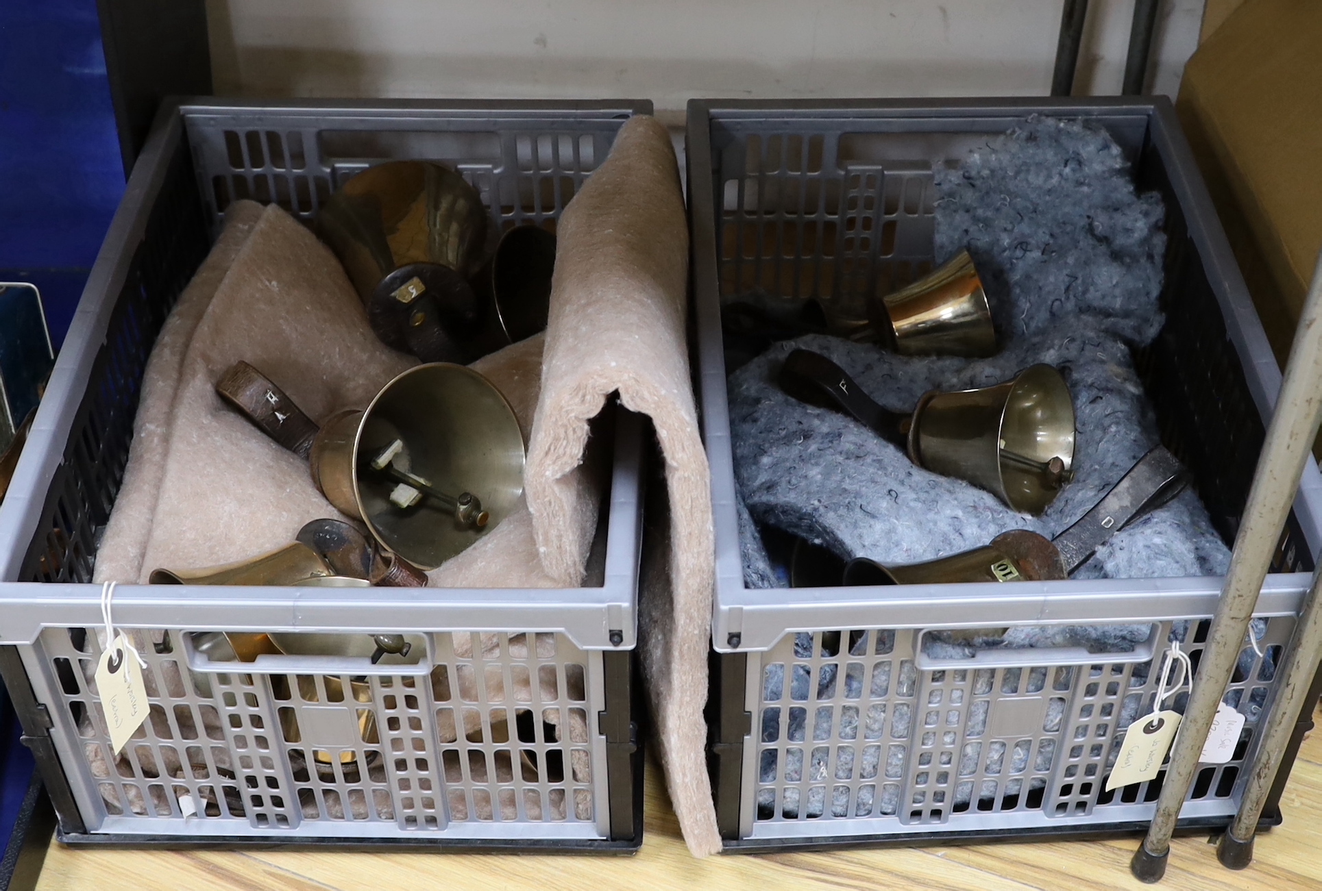 A set of thirty two musical handbells, full chromatic scale, circa 1900, largest 23cm, including leather strap